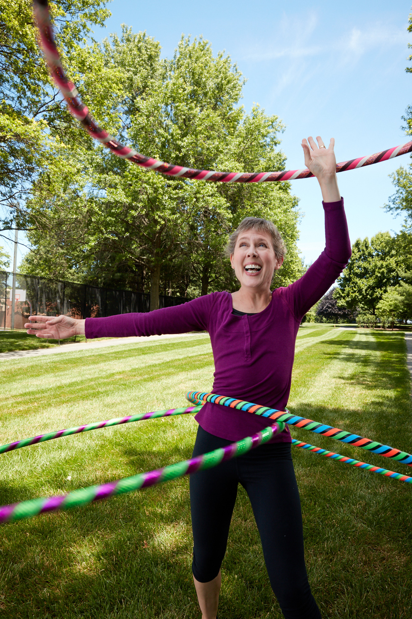 A woman twirling multiple hula hoops. Photo by Washington DC advertising photographer Tracey Brown