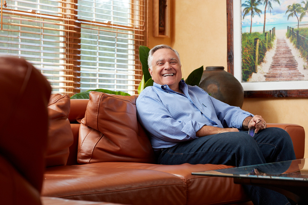 A man sits smiling. Photo by Baltimore MD Editorial Photographer Tracey Brown
