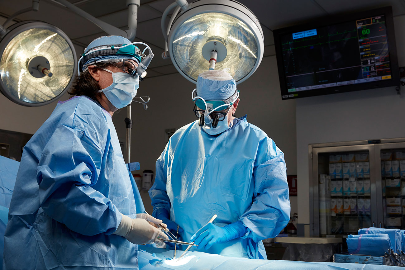 Two doctors in an operating room. Photography by healthcare photographer Tracey Brown