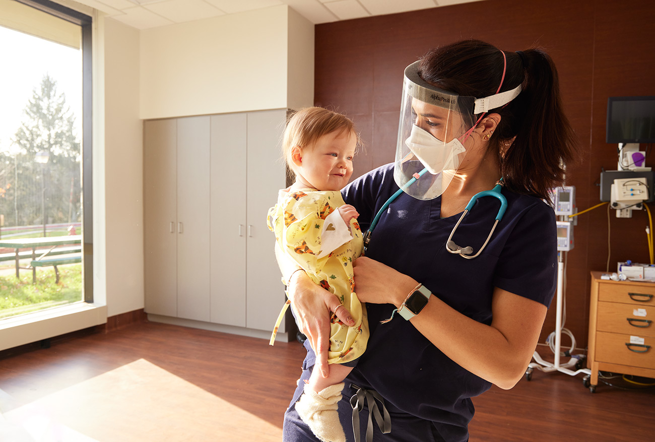 A nurse holding an infant